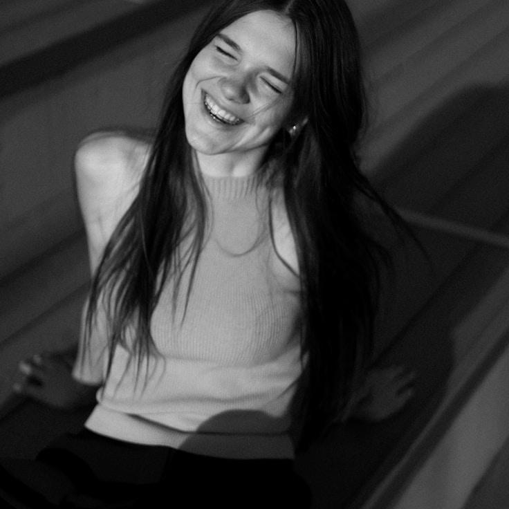 Avery Malik, Lead Design Curator at Marble Collect Top, reviewing corporate floral arrangements